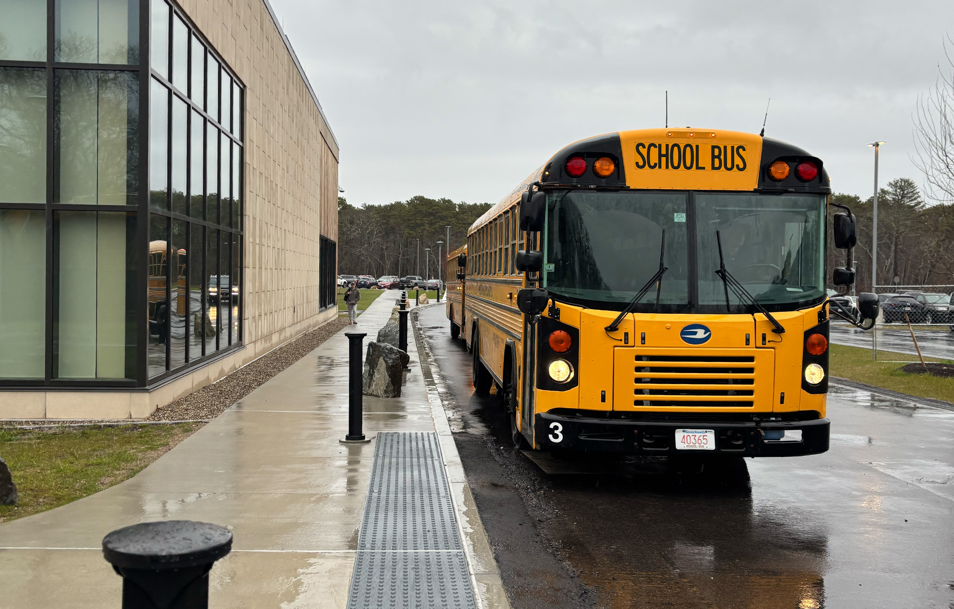 Gelber amerikanischer Schulbus vor Schule