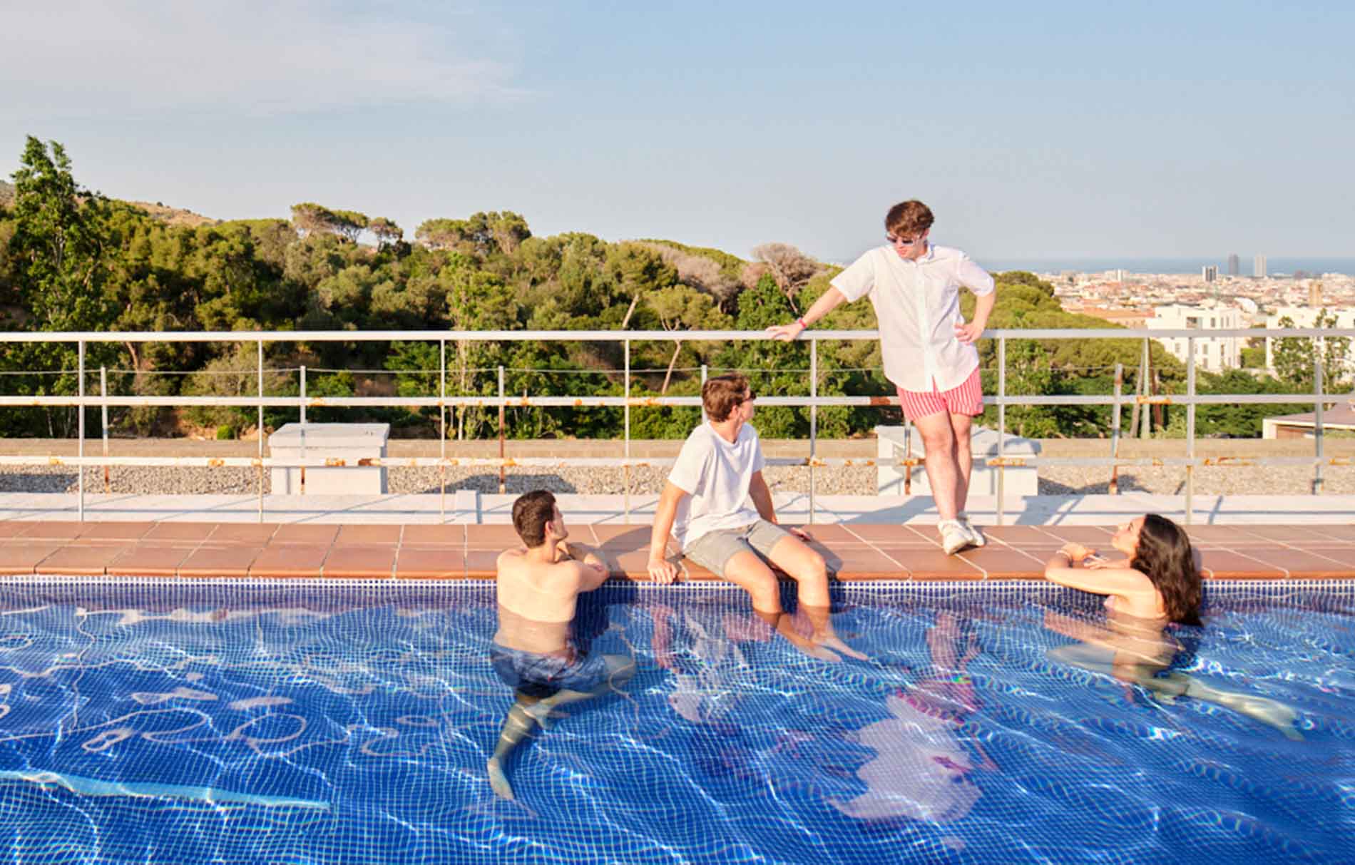 Vier Jugendliche am Pool unterhalten sich